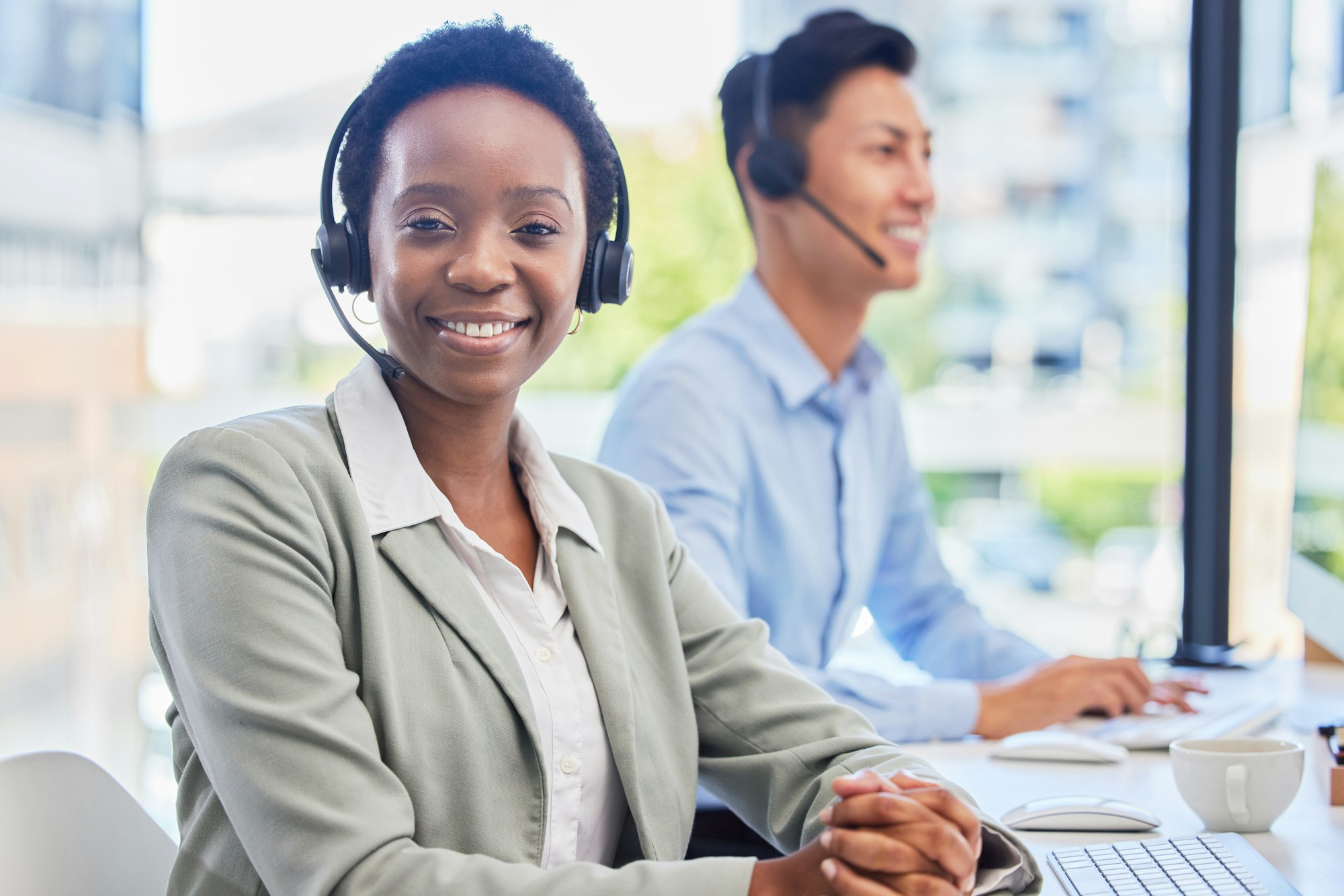 Black woman, telemarketing and smile at help desk for communication, customer support or contact in